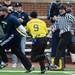 Former Michigan football player Chris Matsos carries the ball past Mark Gutzwiller during the annual alumni flag football game before spring practice at Michigan Stadium on Saturday, April 13, 2013. Melanie Maxwell I AnnArbor.com